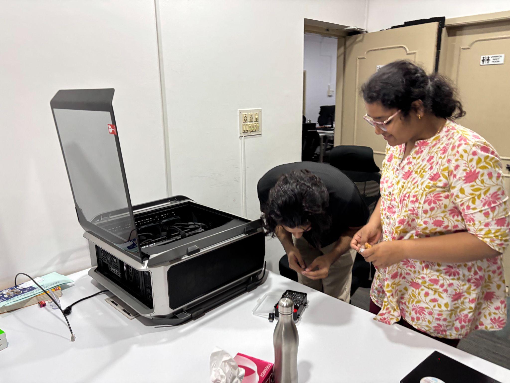 Two people working on the gaming PC
