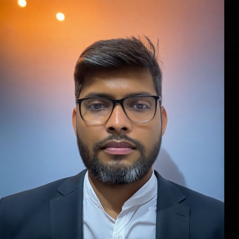 A man with glasses wearing a suit jacket